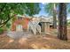 A spacious backyard featuring a deck, stairs, mature trees, and storage building at 1866 Wildwood Ne Pl, Atlanta, GA 30324