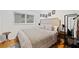 Bedroom with window, headboard, hardwood floor, and bedside table lamp at 1866 Wildwood Ne Pl, Atlanta, GA 30324