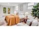 A well-lit bedroom with hardwood floors, a cozy seating area, and french doors to the outdoors at 1866 Wildwood Ne Pl, Atlanta, GA 30324
