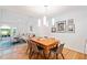 Open-concept living and dining area with hardwood floors, a vaulted ceiling, and modern light fixture at 1866 Wildwood Ne Pl, Atlanta, GA 30324