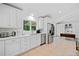 Modern kitchen with stainless steel appliances, white cabinetry, quartz countertop, and tile flooring at 1866 Wildwood Ne Pl, Atlanta, GA 30324