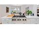 Modern kitchen with stainless steel appliances, white cabinetry, quartz countertop, and tile flooring at 1866 Wildwood Ne Pl, Atlanta, GA 30324