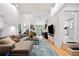 Spacious living room with high ceilings, modern furniture, and a view of the open kitchen at 1866 Wildwood Ne Pl, Atlanta, GA 30324