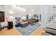 Open-concept living room with high ceilings, modern furniture, and a view of the open kitchen at 1866 Wildwood Ne Pl, Atlanta, GA 30324