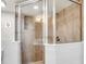 A luxurious shower with stone walls, glass doors, and sleek hardware at 1866 Wildwood Ne Pl, Atlanta, GA 30324