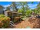 Charming back porch with steps leading to a terraced yard and lush landscaping at 2994 Cathy Ann Nw Ct, Acworth, GA 30101