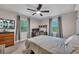 Bright bedroom with natural light, a ceiling fan, and a cozy workspace at 2994 Cathy Ann Nw Ct, Acworth, GA 30101