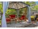 Comfortable outdoor gazebo featuring red seating and privacy curtains, perfect for relaxing at 2994 Cathy Ann Nw Ct, Acworth, GA 30101