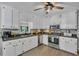 Bright kitchen with stainless appliances, white cabinetry and a large sink under a window at 2994 Cathy Ann Nw Ct, Acworth, GA 30101
