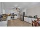 Spacious kitchen with stainless steel appliances, ample white cabinetry, and light wood flooring at 2994 Cathy Ann Nw Ct, Acworth, GA 30101