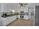 Bright kitchen with stainless appliances, white cabinetry and a large sink under a window at 2994 Cathy Ann Nw Ct, Acworth, GA 30101