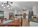 Open-concept kitchen and dining area with stainless appliances, white cabinets, and wood furnishings at 2994 Cathy Ann Nw Ct, Acworth, GA 30101