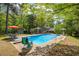 Stunning backyard pool nestled among lush trees, offering privacy and relaxation at 2994 Cathy Ann Nw Ct, Acworth, GA 30101