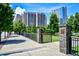 Charming gated entrance to a park, showcasing a beautiful stone pillar and greenery lined sidewalk and well manicured garden at 57 Forsyth Nw St # 12E, Atlanta, GA 30303