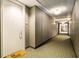 Neutral hallway with patterned carpet leading to doorways and overhead lighting at 57 Forsyth Nw St # 12E, Atlanta, GA 30303