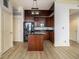 Modern kitchen with dark cabinets, granite countertops, and a central island at 57 Forsyth Nw St # 12E, Atlanta, GA 30303
