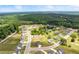 Beautiful aerial view of a modern community with lush greenery and a serene pond at 837 Porches Way, Dacula, GA 30019