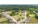 A beautiful aerial view of a modern community, lush greenery, and home with large backyard at 837 Porches Way, Dacula, GA 30019