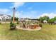 Inviting backyard with a fire pit surrounded by seating, flower barrels, and strung lights at 837 Porches Way, Dacula, GA 30019