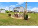 Beautiful backyard featuring a stone fire pit with Adirondack chairs at 837 Porches Way, Dacula, GA 30019