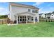 Spacious backyard featuring covered patio and ample green space at 837 Porches Way, Dacula, GA 30019