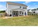 Spacious backyard with covered patio, seating area and large grassy area at 837 Porches Way, Dacula, GA 30019