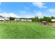 A wide open backyard with healthy lawn, shed, fence and garden boxes on a sunny day at 837 Porches Way, Dacula, GA 30019