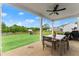 Spacious backyard view of the patio with a table, chairs and ceiling fan at 837 Porches Way, Dacula, GA 30019