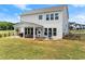 Large backyard with a covered patio, ample seating, and green space, perfect for relaxing and entertaining guests at 837 Porches Way, Dacula, GA 30019