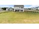 Extensive backyard with a covered patio, grassy area, and wood fencing at 837 Porches Way, Dacula, GA 30019