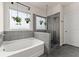 Modern bathroom showcasing a soaking tub and a glass-enclosed shower at 837 Porches Way, Dacula, GA 30019