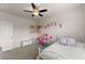 Bright bedroom with charming decor, featuring a playful dollhouse and comfortable furnishings, perfect for a  at 837 Porches Way, Dacula, GA 30019