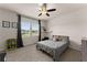 Bright bedroom with neutral carpet, large window, and modern ceiling fan at 837 Porches Way, Dacula, GA 30019