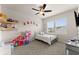 Bright bedroom with charming decor, including a playful dollhouse and comfortable furnishings, perfect for a  at 837 Porches Way, Dacula, GA 30019