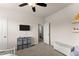 Neutral bedroom featuring a ceiling fan, TV, and ample storage, creating a calm and versatile space at 837 Porches Way, Dacula, GA 30019