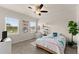 Comfortable bedroom with natural light, ceiling fan, and cozy decor, offering a serene retreat at 837 Porches Way, Dacula, GA 30019
