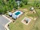 Aerial view of a community pool with a splash pad and picnic pavilion at 837 Porches Way, Dacula, GA 30019