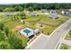 Aerial view of a neighborhood pool with playground, covered seating, and fenced in community at 837 Porches Way, Dacula, GA 30019