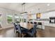 Bright dining area with stylish furnishings, lighting, and backyard views at 837 Porches Way, Dacula, GA 30019
