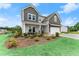 Charming two-story home boasting stylish gray siding, a welcoming front porch, and lush landscaping at 837 Porches Way, Dacula, GA 30019