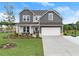 Charming two-story home with a well-manicured lawn, a basketball hoop, and a two-car garage at 837 Porches Way, Dacula, GA 30019