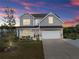 Charming two-story home featuring a well-manicured lawn, two-car garage, and inviting front porch area at 837 Porches Way, Dacula, GA 30019
