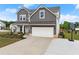 Charming two-story home featuring a well-manicured lawn, two-car garage, and inviting front porch area at 837 Porches Way, Dacula, GA 30019
