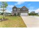 Charming two-story home featuring a well-manicured lawn, two-car garage, and inviting front porch area at 837 Porches Way, Dacula, GA 30019