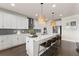 Open kitchen showcases a large island, white cabinets, and modern fixtures at 837 Porches Way, Dacula, GA 30019