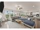 Bright open-concept living room with hardwood floors, large windows, and comfortable seating at 837 Porches Way, Dacula, GA 30019