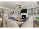 Cozy living room features a fireplace, built-in bookshelves, and hardwood floors at 837 Porches Way, Dacula, GA 30019