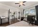 Bright and open home office with hardwood floors, french doors, and a well-lit workspace at 837 Porches Way, Dacula, GA 30019