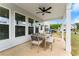 Covered patio with outdoor dining area and backyard views at 837 Porches Way, Dacula, GA 30019