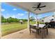 Inviting covered patio with outdoor dining and views of expansive lawn and swimming pool at 837 Porches Way, Dacula, GA 30019